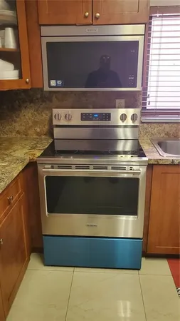 a stove top oven sitting inside of a kitchen