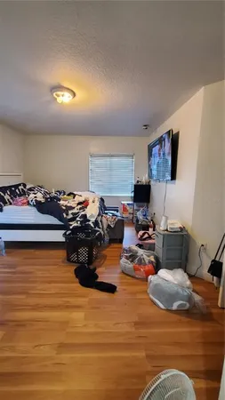 a bed room with furniture and a flat screen tv