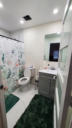 a bathroom with a sink toilet and mirror