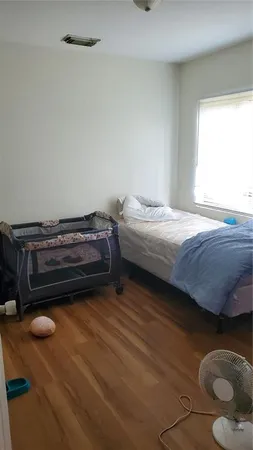 a bedroom with a bed and a potted plant