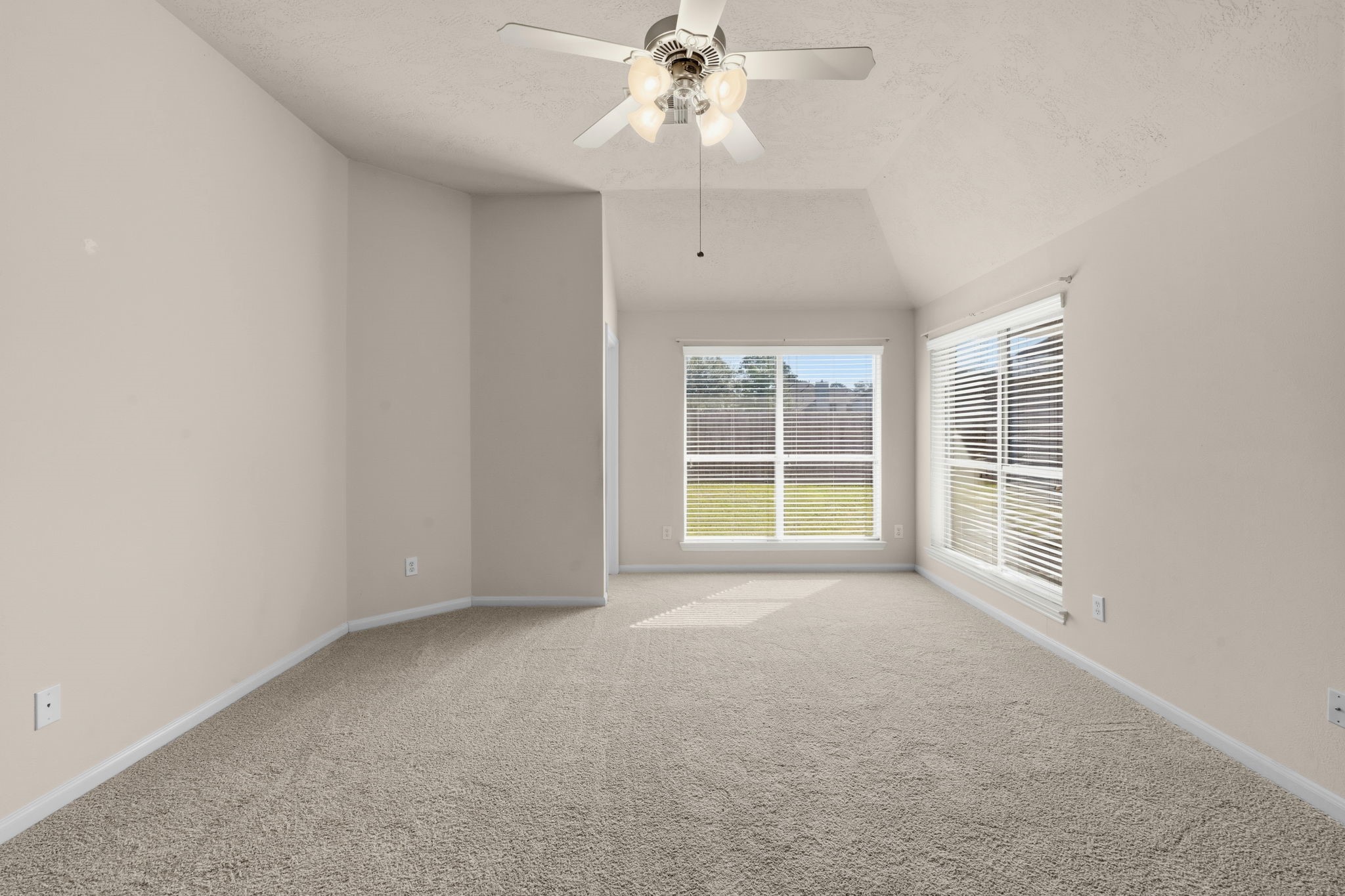 9122 Sunny Ridge Drive Houston, TX 77095 - Photo 11 of 15 an empty room with a ceiling fan and windows