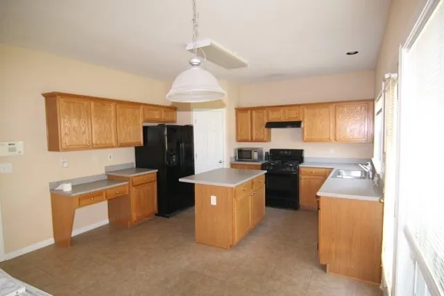 a kitchen with cabinets a sink and a stove