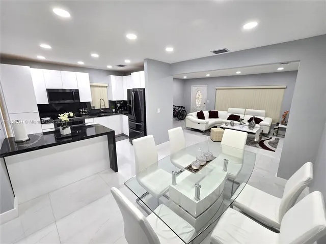 a living room with fireplace furniture and a flat screen tv