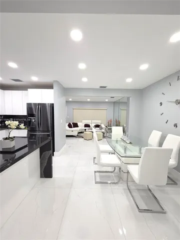 a living room with furniture and kitchen view