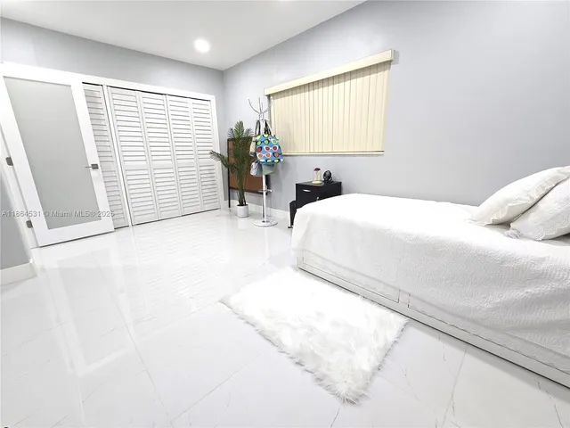 a large white bed in a white room