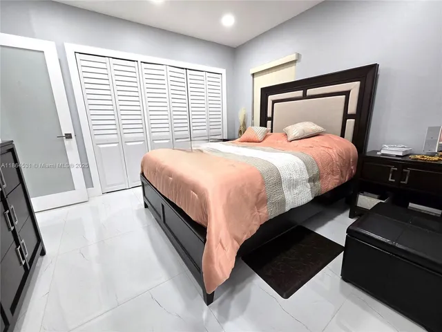 a bed sitting in a bedroom next to a window