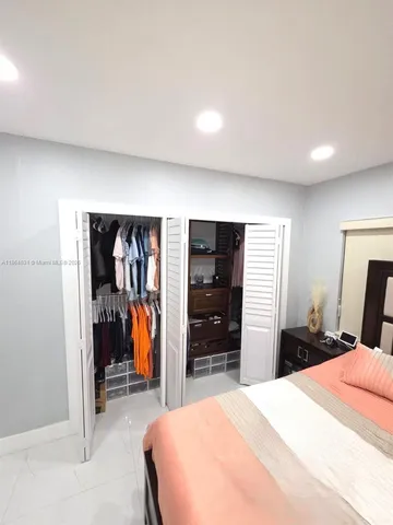 a bedroom with a bed and a closet