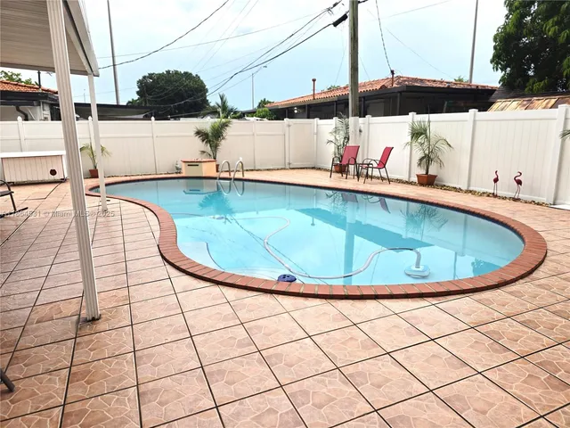 a view of a swimming pool with a chairs