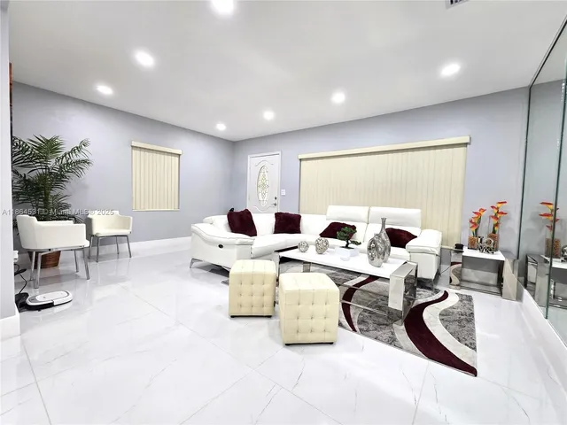 a living room with furniture potted plant and a large window