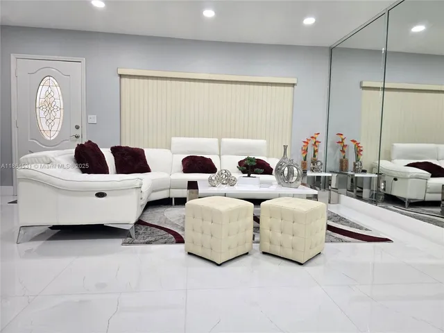 a living room with couches and chandelier