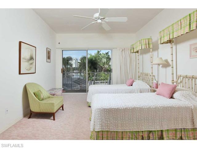 306 Devils Bight Naples, FL 34103 - Photo 8 of 17 a living room with furniture and a large window