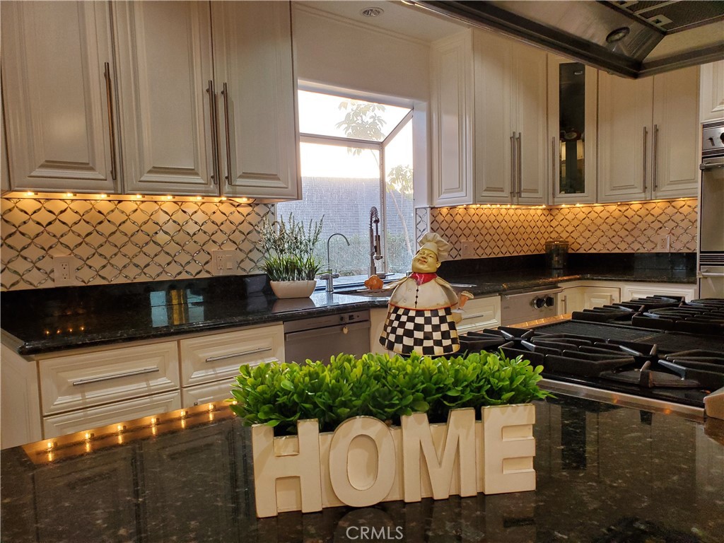 7901 Berger Avenue Playa del Rey, CA 90293 - Photo 15 of 67 a kitchen with stainless steel appliances kitchen island granite countertop a stove a sink and a microwave