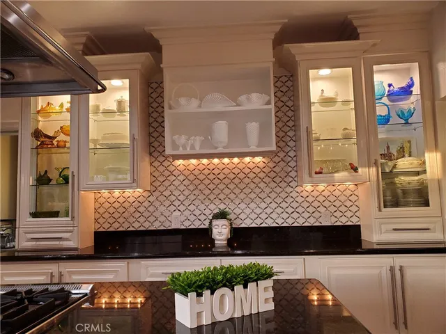 a kitchen with stainless steel appliances kitchen island granite countertop a stove and cabinets