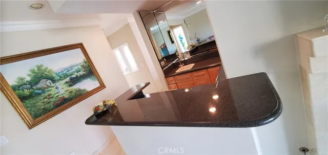 a kitchen with granite countertop a stove a sink and a microwave