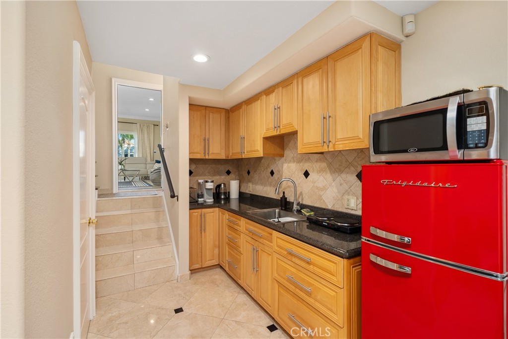 7901 Berger Avenue Playa del Rey, CA 90293 - Photo 27 of 67 a kitchen with granite countertop a stove a sink and a microwave