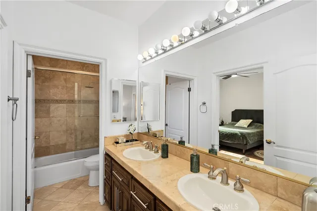 a bedroom with bed and flat tv screen on dresser