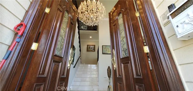 a pathway of a house with a yard and potted plants