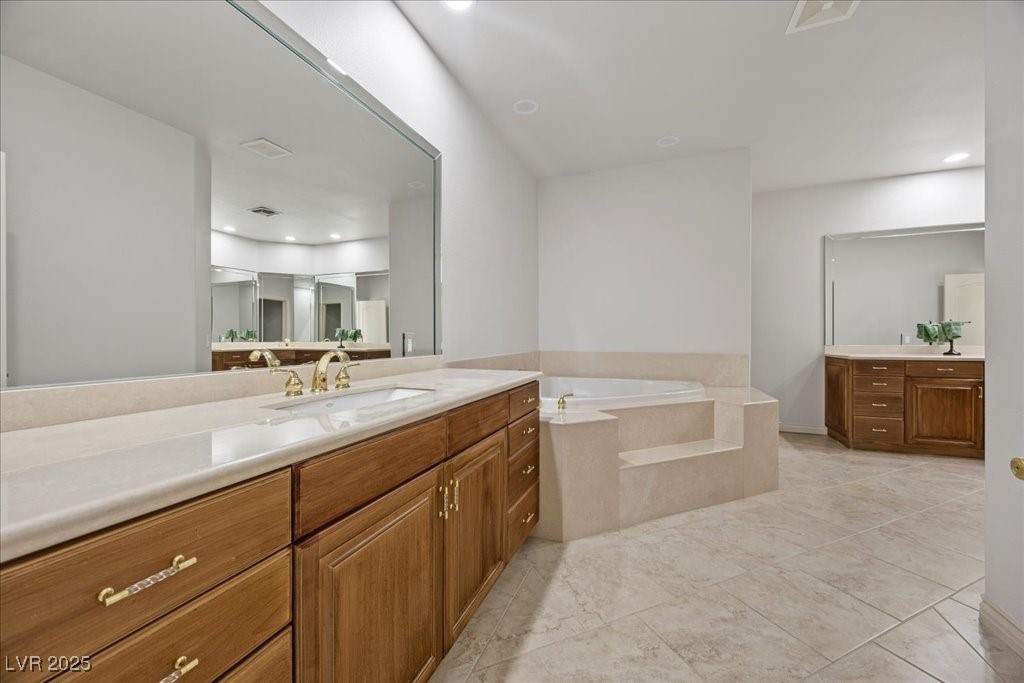 640 Quail Covey Road Henderson, NV 89002 - Photo 33 of 75 4th Bathroom featuring two vanities and a garden tub