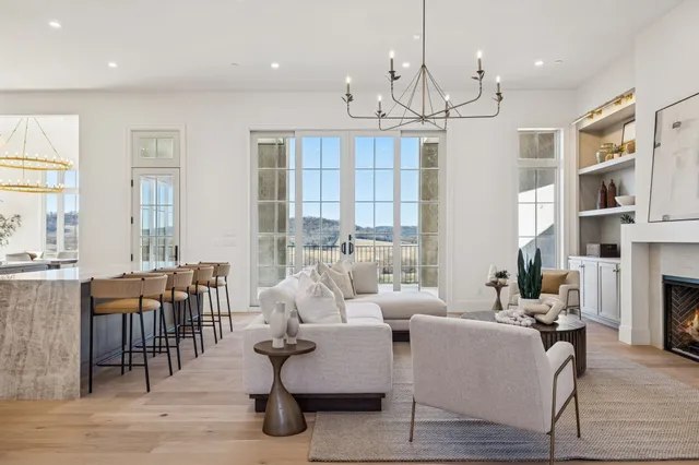 a kitchen with a dining table chairs and white cabinets