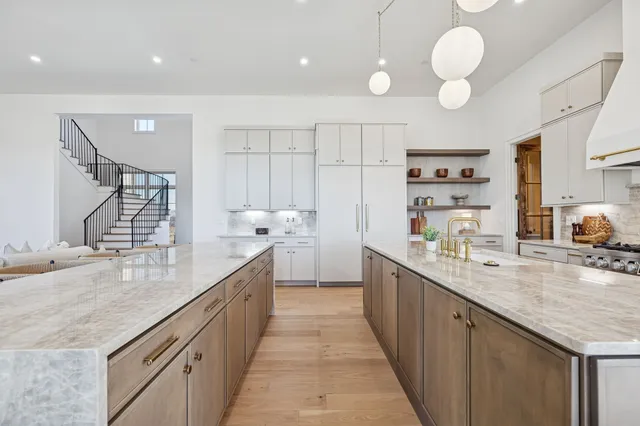 a kitchen with a sink dishwasher stove and cabinets