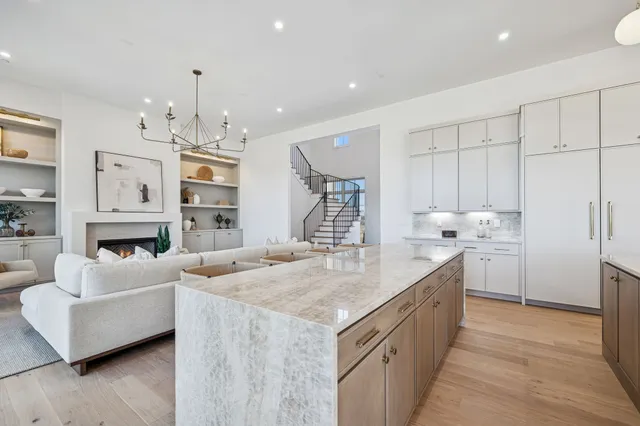 a bedroom with a large bed and a fireplace