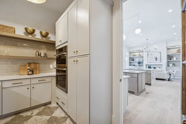 a view of a hallway with wooden shelves