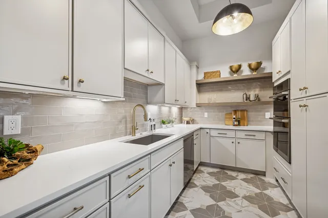 a bathroom with a granite countertop sink a mirror and shower