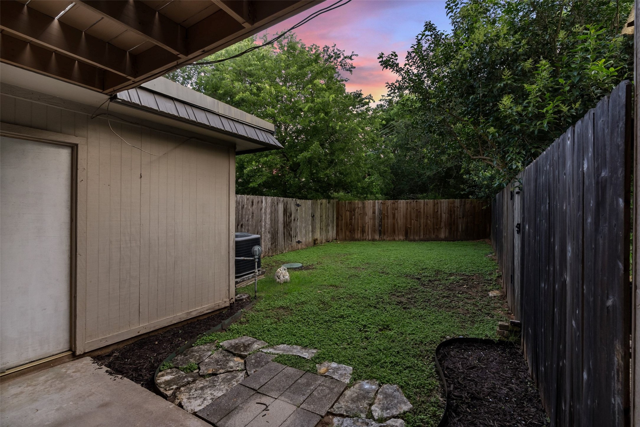702 Castle Ridge Road, Unit C Austin, TX 78746 - Photo 20 of 36 The fenced backyard offers privacy and room to relax.