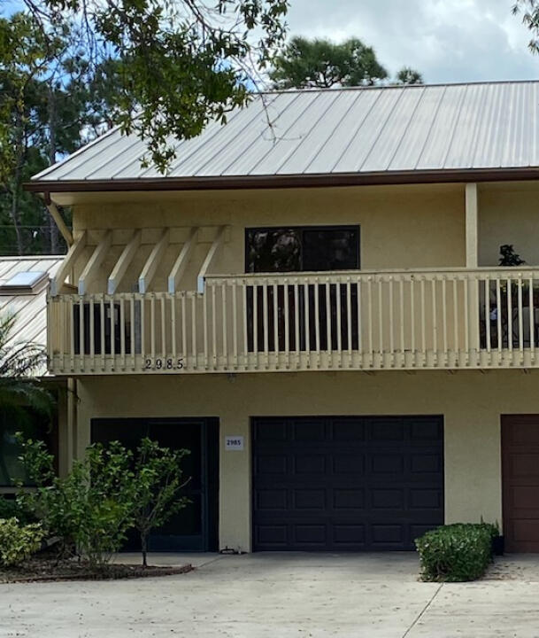 2985 Bent Pine Drive Fort Pierce, FL 34951 - Photo 1 of 29 a front view of a house with garden