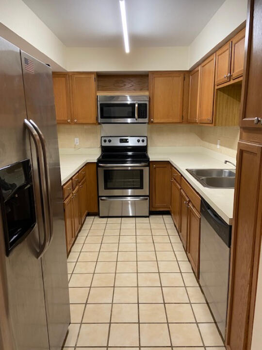 2985 Bent Pine Drive Fort Pierce, FL 34951 - Photo 6 of 29 a kitchen with stainless steel appliances granite countertop a refrigerator and a stove top oven