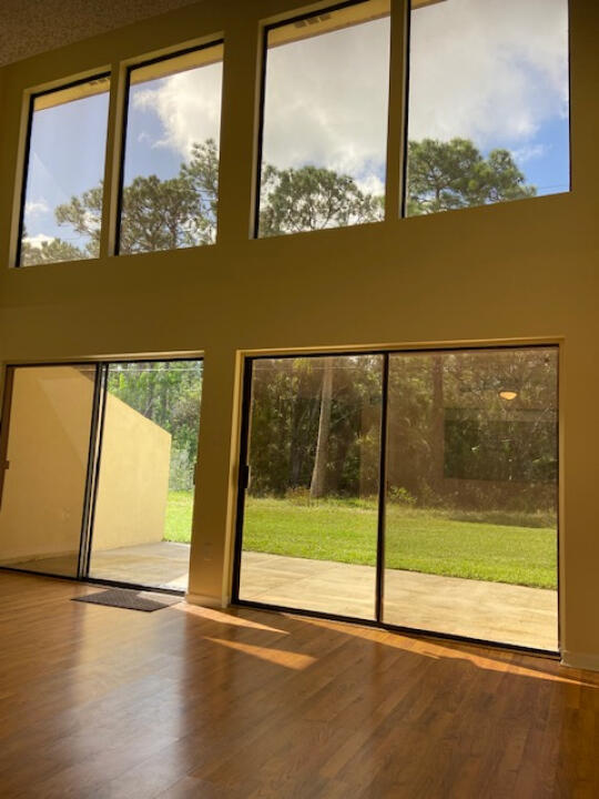 2985 Bent Pine Drive Fort Pierce, FL 34951 - Photo 9 of 29 a view of an empty room with wooden floor and a window