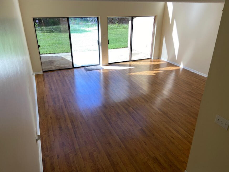 2985 Bent Pine Drive Fort Pierce, FL 34951 - Photo 10 of 29 a view of an empty room with wooden floor and a window