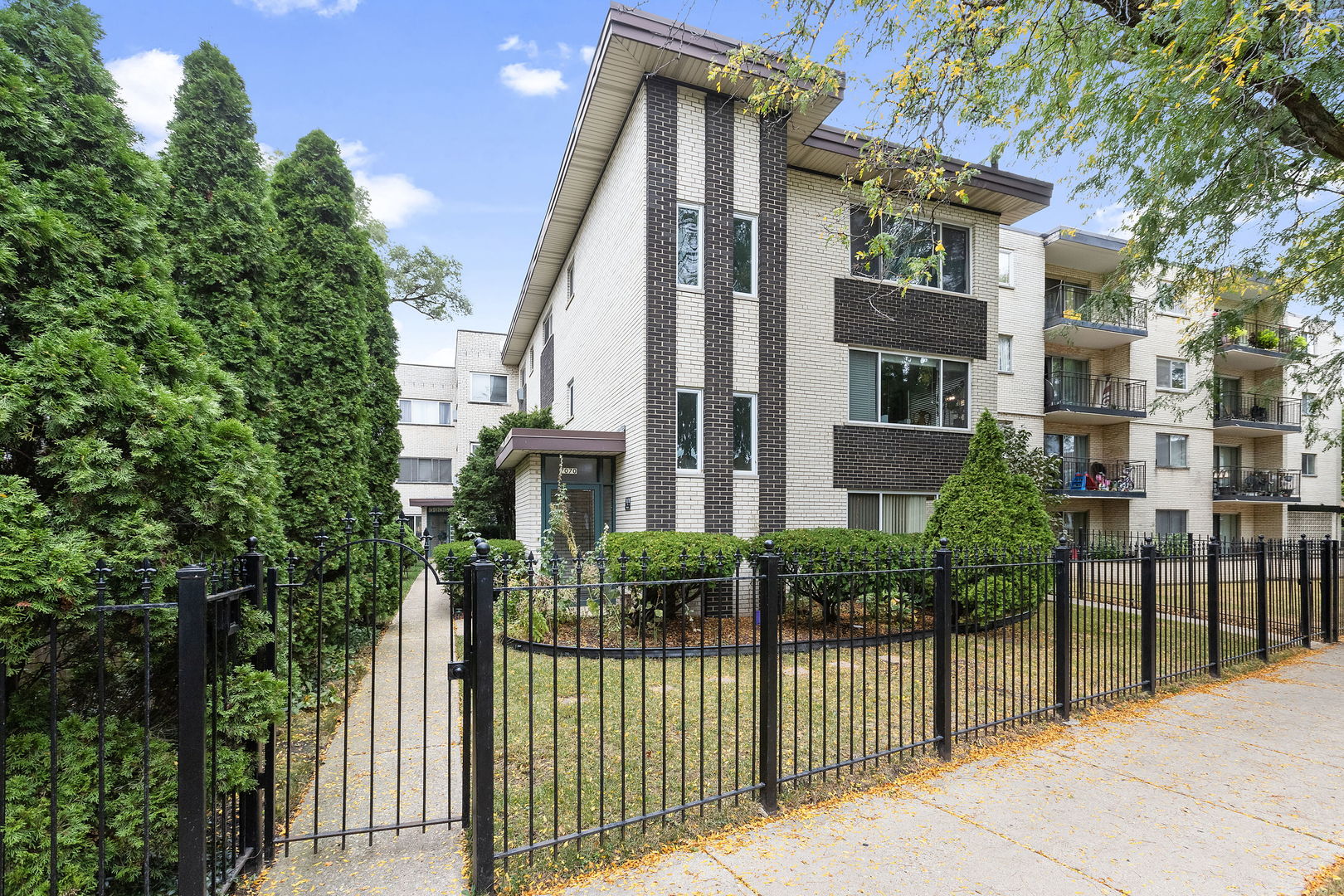 a view of a house with brick walls and plants