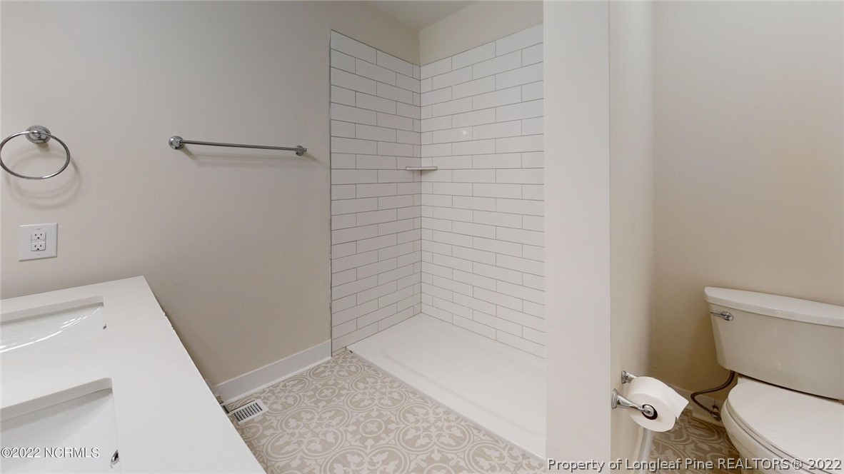 344 J Burns Road Vass, NC 28394 - Photo 16 of 50 a bathroom with a toilet and a shower
