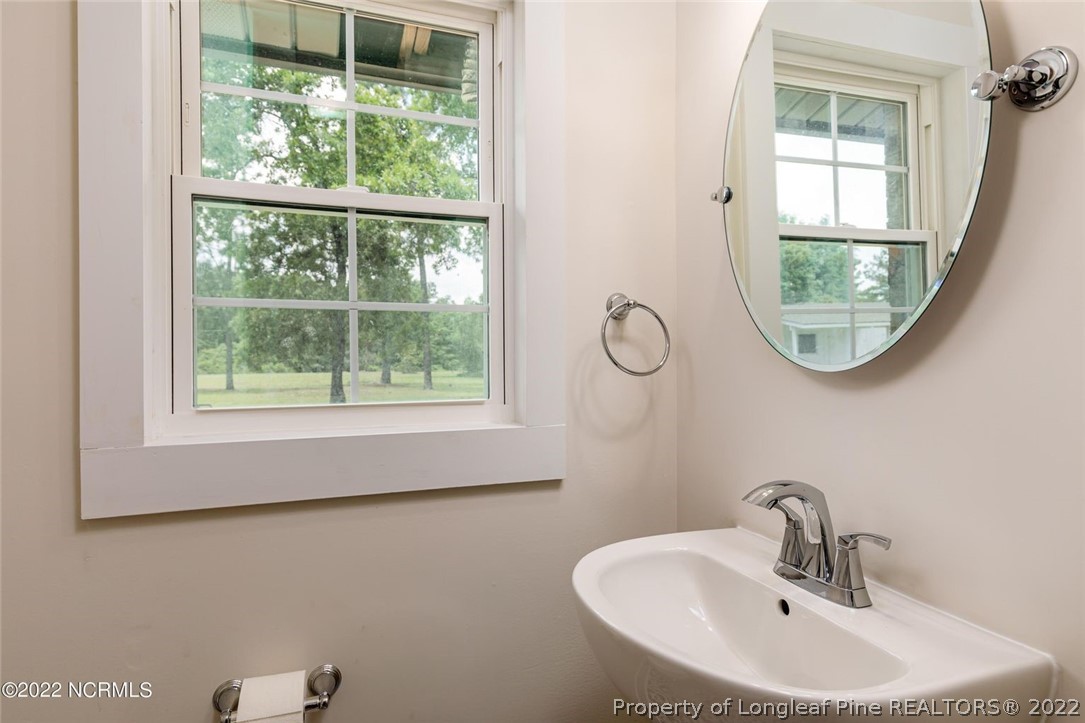 344 J Burns Road Vass, NC 28394 - Photo 21 of 50 a bathroom with a sink and a mirror