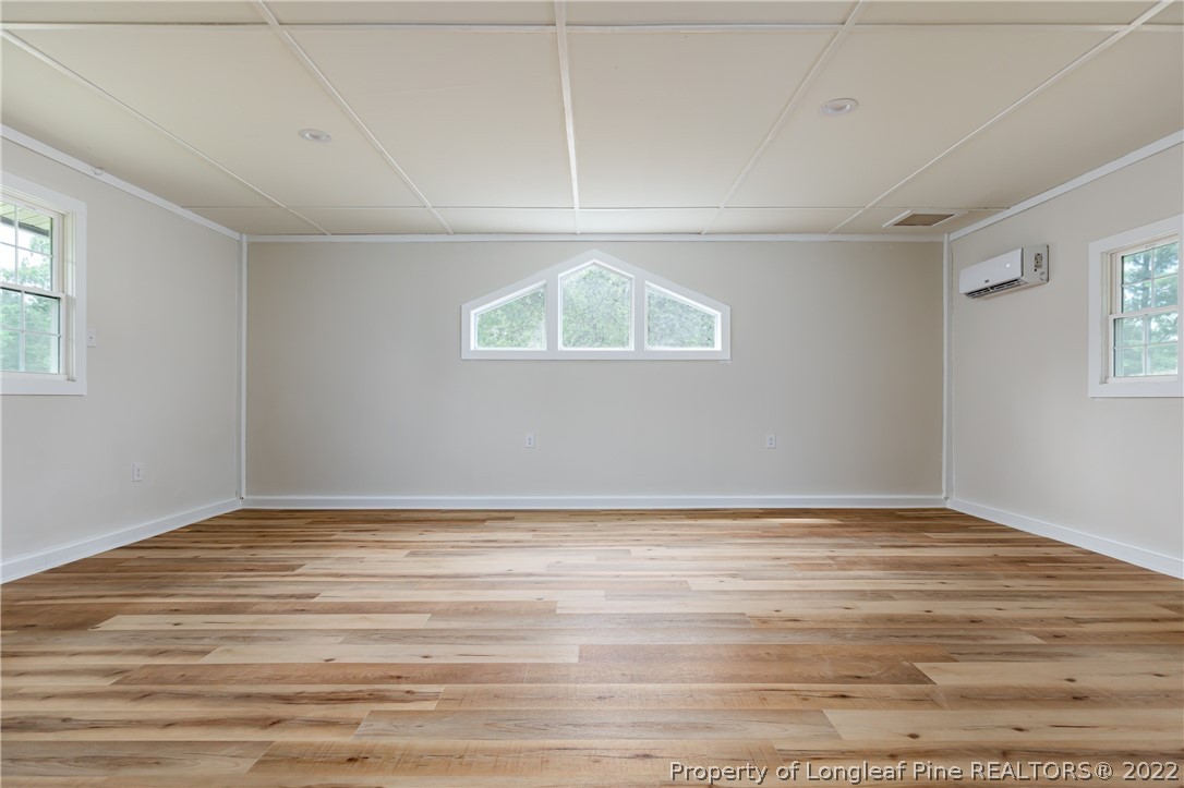 344 J Burns Road Vass, NC 28394 - Photo 25 of 50 a view of an empty room with wooden floor and a window