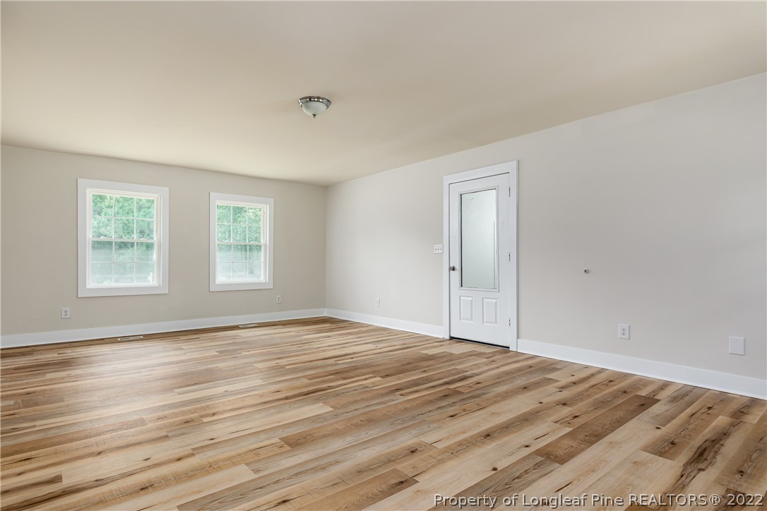 344 J Burns Road Vass, NC 28394 - Photo 28 of 50 a view of an empty room with wooden floor and window