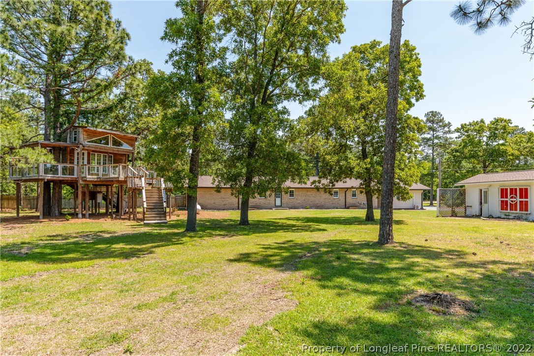 344 J Burns Road Vass, NC 28394 - Photo 33 of 50 a view of a house with a big yard and large trees
