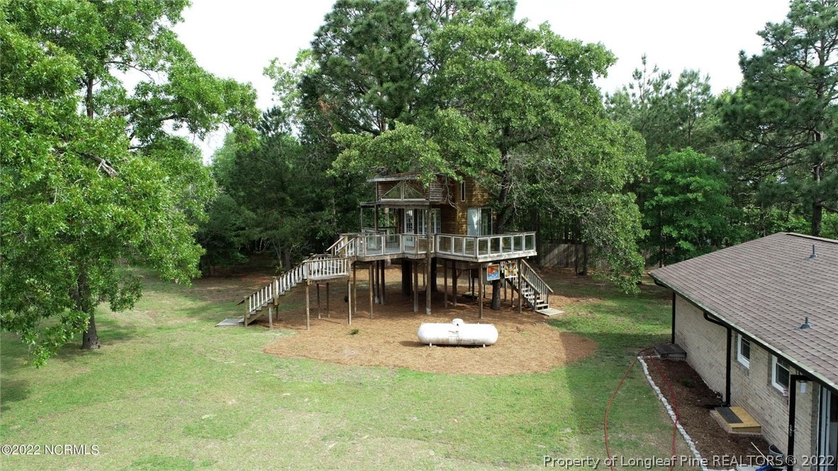 344 J Burns Road Vass, NC 28394 - Photo 43 of 50 a view of a house with pool and trees in the background
