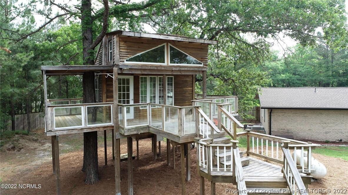344 J Burns Road Vass, NC 28394 - Photo 45 of 50 a view of house with a deck and furniture