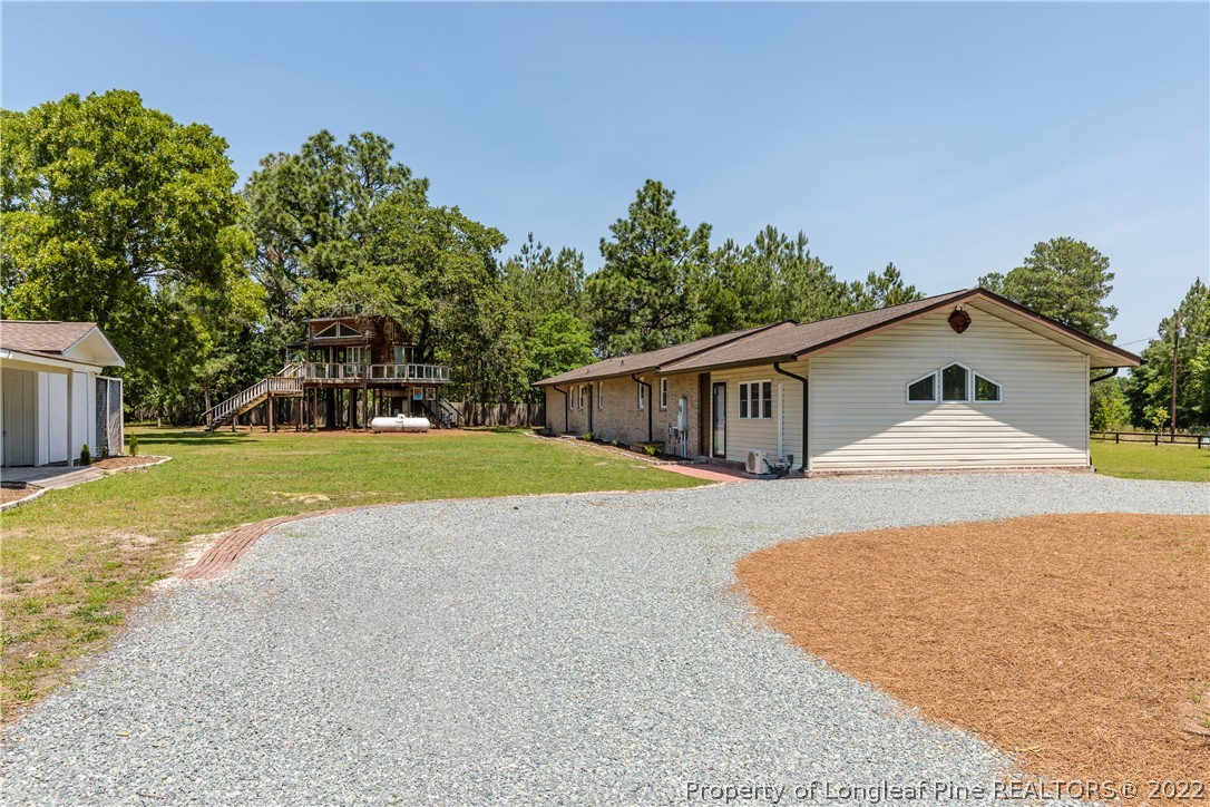 344 J Burns Road Vass, NC 28394 - Photo 47 of 50 a view of a house with backyard and trees