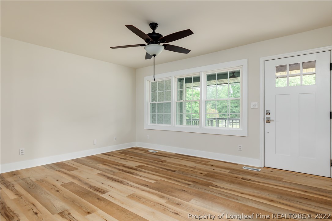 344 J Burns Road Vass, NC 28394 - Photo 5 of 50 a view of a livingroom with a ceiling fan & a window