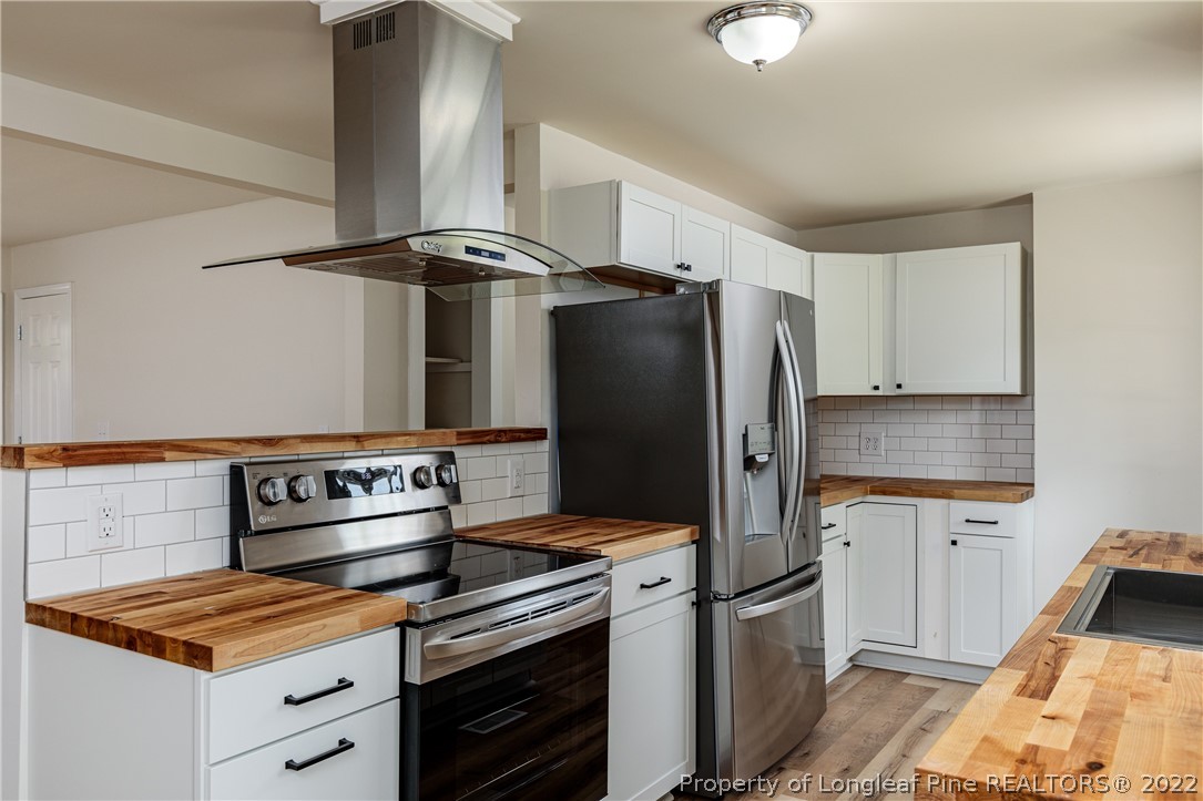 344 J Burns Road Vass, NC 28394 - Photo 7 of 50 a kitchen with stainless steel appliances granite countertop a refrigerator and a stove