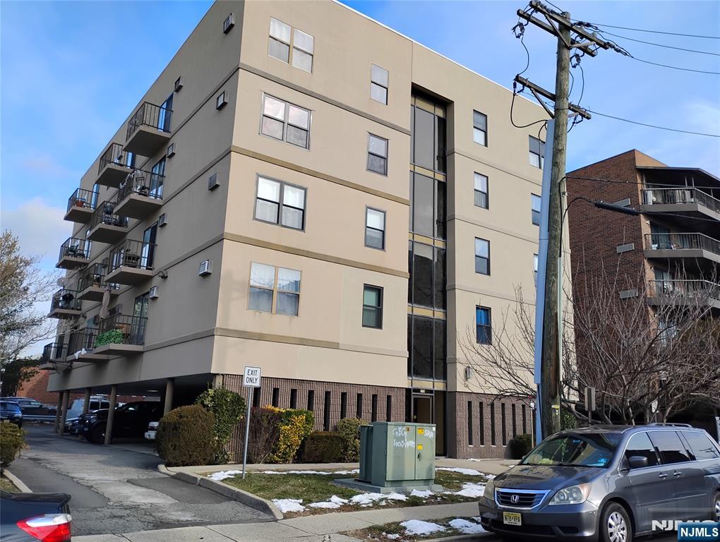 a view of a street that has couple of cars parked on the road