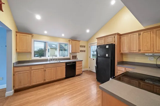 a kitchen with a refrigerator and a sink