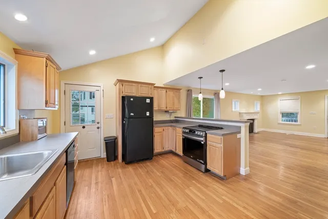 a kitchen with stainless steel appliances granite countertop a stove and a refrigerator