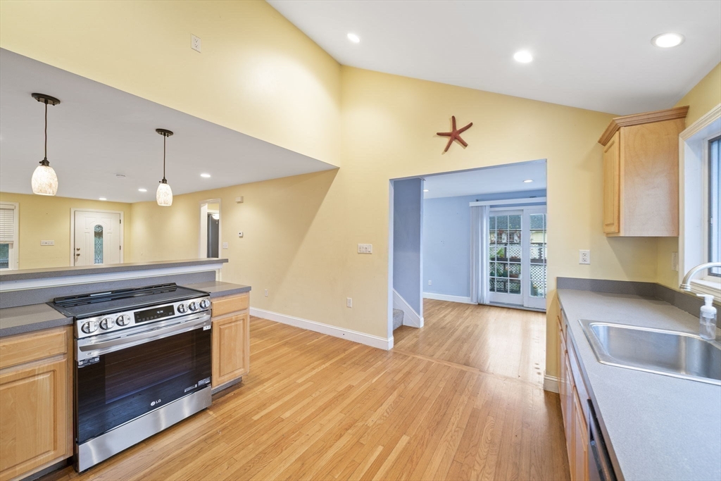 53 Mountford Road Hull, MA 02045 - Photo 9 of 35 a kitchen with stainless steel appliances granite countertop a stove and a wooden floors