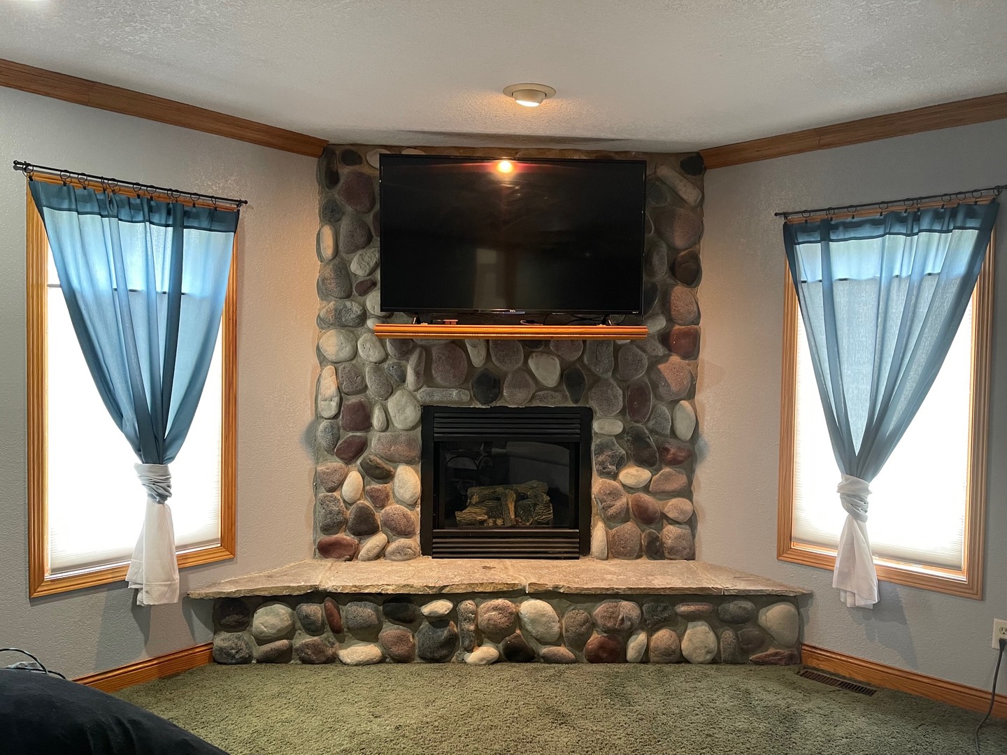 382 Keigwin Road Walnut, IL 61376 - Photo 29 of 49 a living room with furniture a flat screen tv and a fireplace