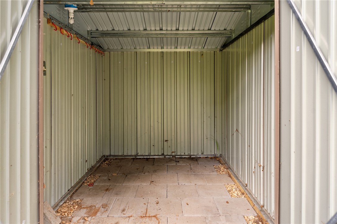 12 Dendy Street Pelzer, SC 29669 - Photo 27 of 31 A robust metal shed offers practical, weather-resistant outdoor storage solutions.