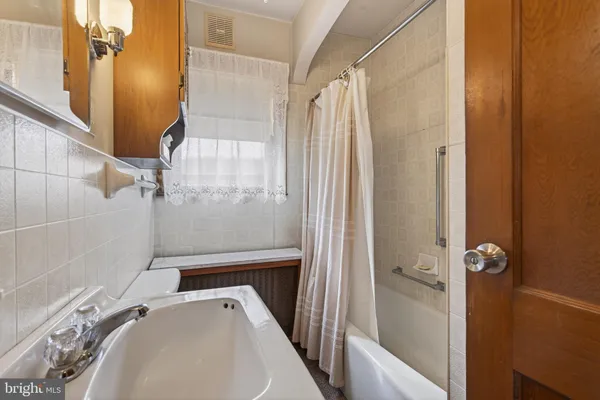 a kitchen with stainless steel appliances granite countertop a stove a refrigerator a sink a stove and white cabinets